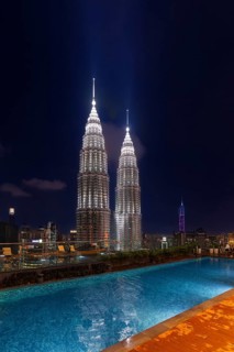 Swimming pool and Petronas Towers, KLCC Twin Towers, interlinked pair of 88-storey illuminated at