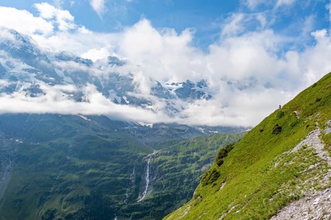 Picturesque mountain landscape with Schmadribachfall waterfall, Breithorn and Tschingelhorn