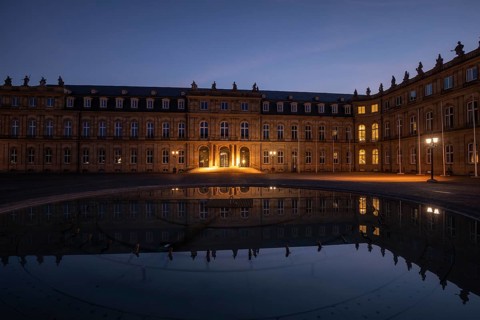 24.4.2026: The illuminated Neues Schloss (New Palace) at dawn, reflected in the water of a fountain