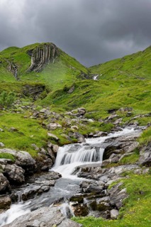 Bergbach Sousbach flows through picturesque green mountain landscape, long exposure, Bernese Alps,