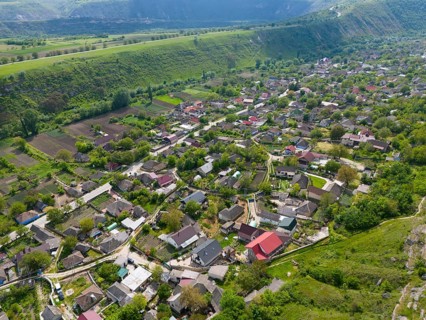 Rural village nestled in a green landscape with hilly environments, aerial view, view of Trebujeni,