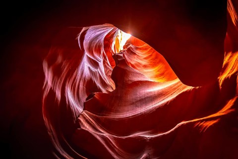 Antelope canyon showing narrow sandstone walls sculpted into distinctive flowing shapes by water