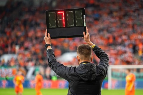 Technical referee shows added time during football match in Lubin, Poland