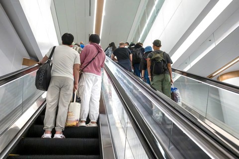Escalator with passers-by, Bangkok, Thailand