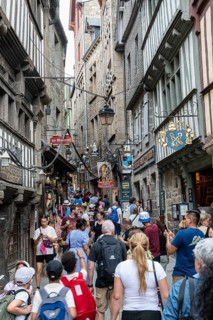 Mass tourism in the historic alleys of Rocky Island, Le Mont Saint Michel monastery island, tourist