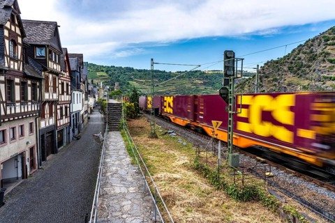 Freight train, in the Upper Middle Rhine Valley, runs directly in front of the residential