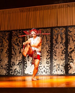 Young Thai man in traditional clothing in a historic show with knives and swords, Old Chiang Mai