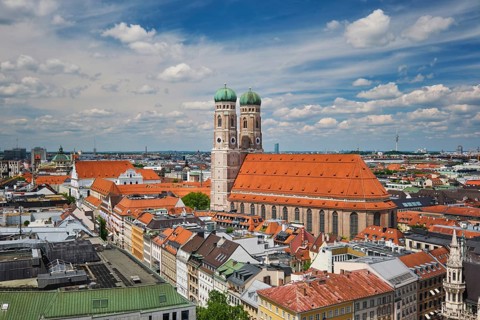 Wide angle aerial view of the iconic Frauenkirche towers and Munich city center architecture under