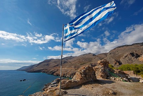 Greek flag flies at the ruins of the old fort, behind Chóra Sfakion on the Libyan Sea and the Leka