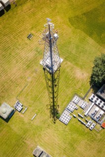 A radio tower towers over the meadow, its shadow is visible, Bunker Anlage, Calw, Germany