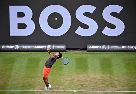 Rinky Hijikata (AUS) in action serving, with a Boss logo on the backboard, BOSS Open 2026, ATP 250