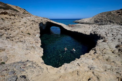 Two swimmers under a natural rock bridge in turquoise water, Kapras, Kapros, Beach, Kapros Beach,