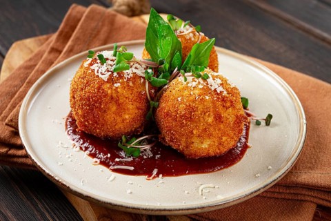 Crispy Arancini appetizer, with parmesan cheese and microgreens, plate, tomato sauce, homemade, no