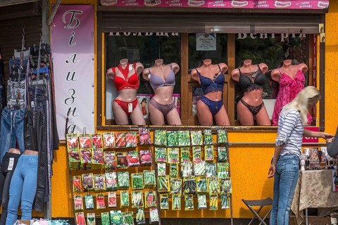 Window mannequins with lingerie, bottom offering rack with vegetable seed bags, Lviv, Ukraine