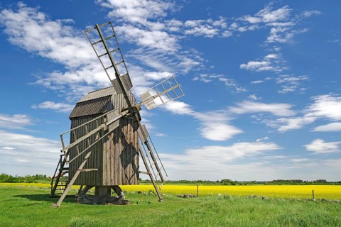 A windmill in a vast field landscape under blue sky and white clouds, Lerkaka, Ölandsleden, Öland,