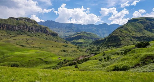 Mountainous landscape of the Cathedral Range mountains and green mountain valley, Drakensberg