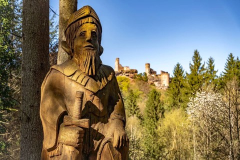 Knight sculpture made of wood in front of the Dahner castle group consisting of the castles