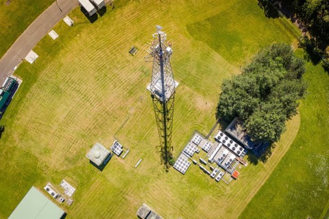 A radio tower in the middle of a green area with technology facilities, bunker plant, Calw, Germany