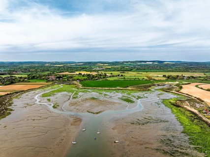 Fields and Farms over Bosham Quay from a drone, Chichester Harbour National Landscape, Chichester,