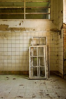 Dilapidated frame of windows leaning against a wall, former lung hospital and lost place health