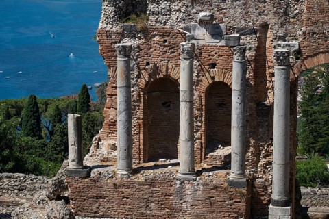 View of ancient theatre pillars and the Mediterranean Sea, Taormina, Sicily, Italy
