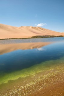 Sand dunes are reflected in Sandwich Harbour Lagoon, Impressive Desert Landscape, Namib Naukluft