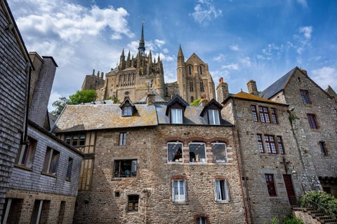 Historic half-timbered houses and stone buildings in the narrow, medieval streets of Le