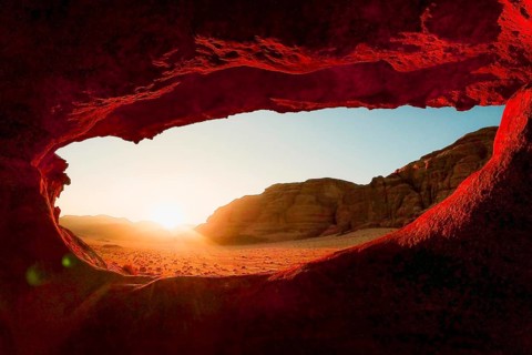 Cinematic view Eye Arch natural rock formation framing sunset wide desert panorama warm sandstone