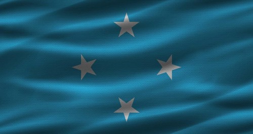 Micronesian flag with fabric texture. Realistic flag of Micronesia waving