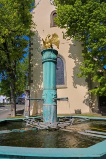 Fountain in front of the Protestant town church, green fountain with golden bird, detail, bird