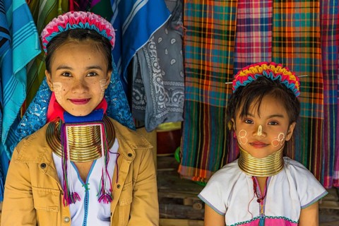 Children from the Karen minority group wearing brass rings around their necks, colorful traditional