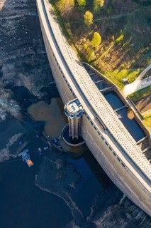 Aerial view of a large dam with water and surrounding forest, emptied Schwarzenbach dam, Forbach,