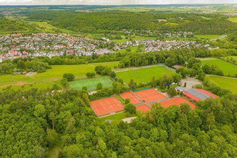 Sports facilities with tennis courts and soccer fields in a hilly, green landscape, Aidlingen