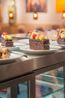 Several vegan chocolate tarts with decoration in a display case, Cafe Kuh, Deckenpfronn, Germany