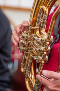 Close-up of a golden wind instrument held by one person, Father's Day, Forest Festival, Aidlingen,