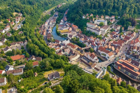 A summer landscape with a city, hills and a river from the air, Hermann Hesse Railway, Calw,