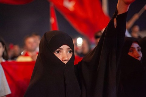 Istanbul, Turkey. 19th July 2016. A young female muslim among the crowds that fill Taksim Square in