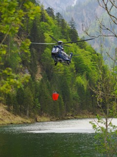 Federal Police helicopters fighting the forest fire on Saurüsselkopf in the Eastern Chiemgau Alps