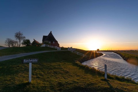 Kirchwarft with pastor and church on Hallig Hooge in the Schleswig-Holstein Wadden Sea National