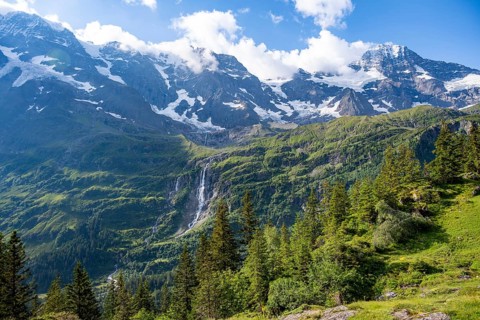 Picturesque mountain landscape with Schmadribachfall waterfall, Breithorn and Grosshorn mountain