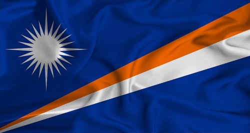 Realistic Marshall Islands flag waving. Close up of flag of Marshall Islands with cloth texture