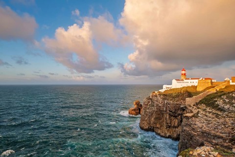 View of the Lighthouse of Cabo de Sao Vicente in Sagres, Algarve, Portugal, at sunrise with