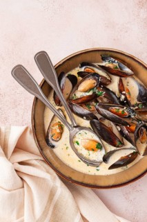 Mussels in creamy garlic sauce, served with fresh herbs and spices, homemade, no people