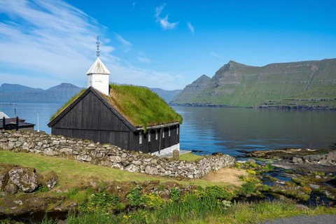 Funningur wooden church, church with grass roof on the fjord, Eysturoy island, Faroe Islands,