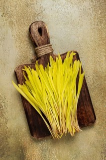 A microgrown corn, a bouquet on a cutting wooden board, no people