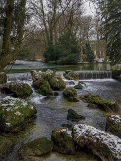 Small waterfall, winter in the English Garden, Munich, Bavaria, Germany
