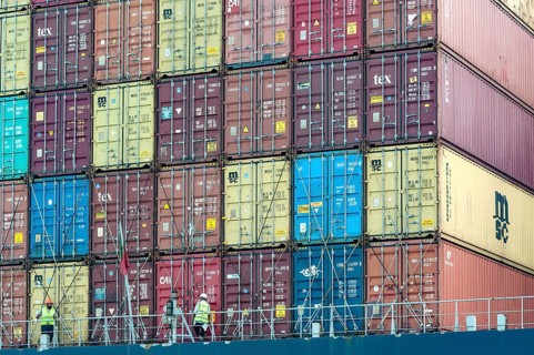 Abu Dhabi, United Arab Emirates. June 23rd 2019 Workers with stacked shipping containers ready for