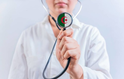 Female doctor holding stethoscope with Algeria flag. National health system of Algeria