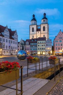 Atmospheric night view of market square with city church and old town hall, Luther city Wittenberg,