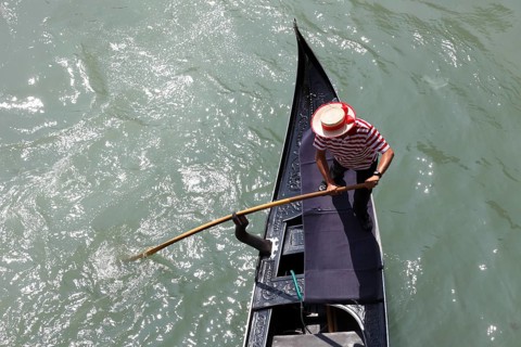 Gondolier on the Grand Canal, Venice, Veneto, Italy